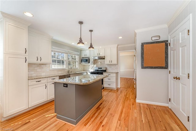 kitchen with crown molding, appliances with stainless steel finishes, and white cabinets