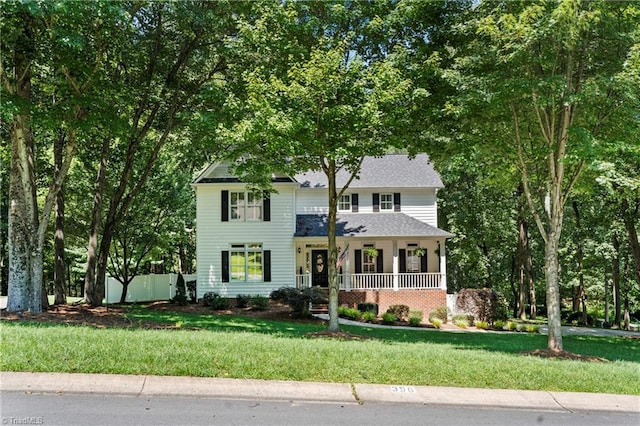 396 Bent Creek Trl, Kernersville, NC 27284 - view of front of house with covered porch, a front yard, and roof with shingles