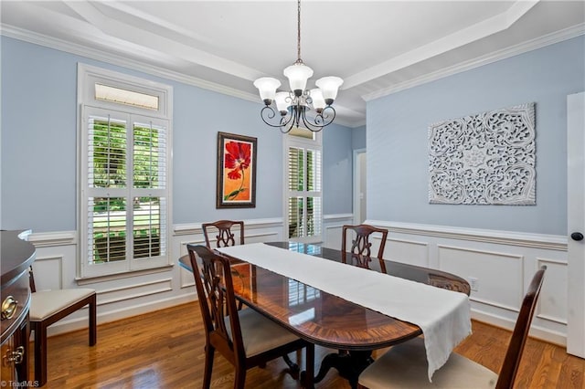 396 Bent Creek Trl, Kernersville, NC 27284 - dining room with a raised ceiling, a chandelier, wood finished floors, crown molding, and wainscoting