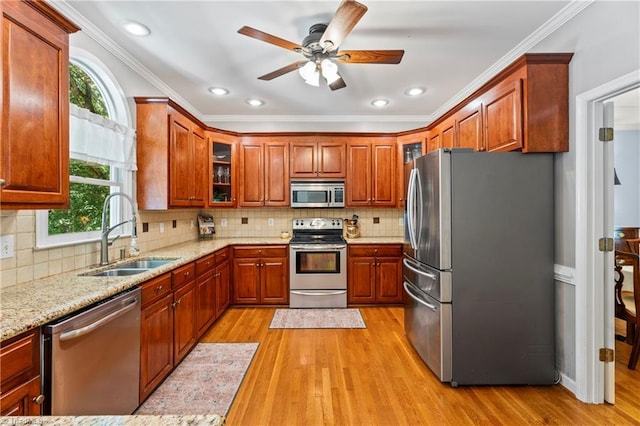 396 Bent Creek Trl, Kernersville, NC 27284 - kitchen featuring appliances with stainless steel finishes, light wood-style floors, light stone counters, glass insert cabinets, and ornamental molding