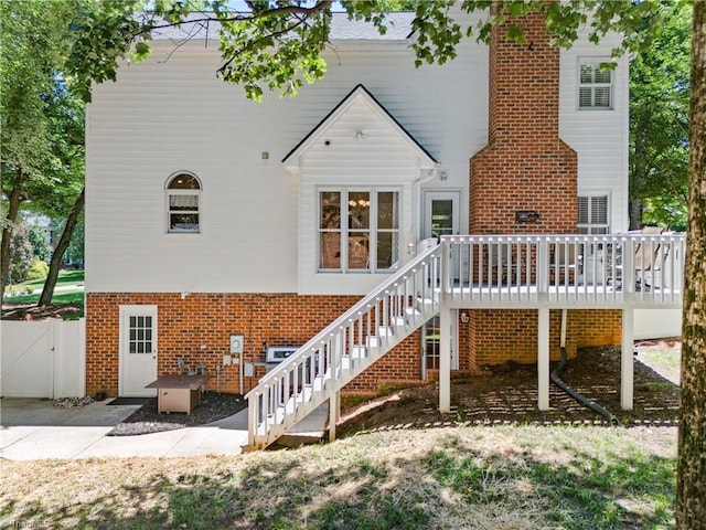 396 Bent Creek Trl, Kernersville, NC 27284 - rear view of property featuring brick siding, stairs, a deck, and a patio