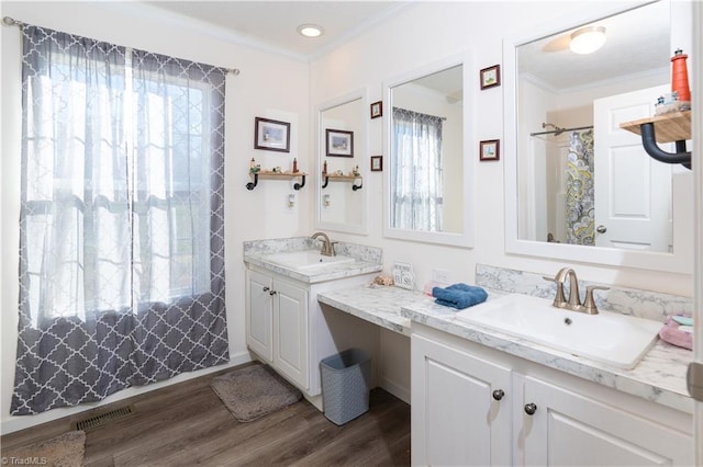 bathroom featuring hardwood / wood-style floors, plenty of natural light, and ornamental molding