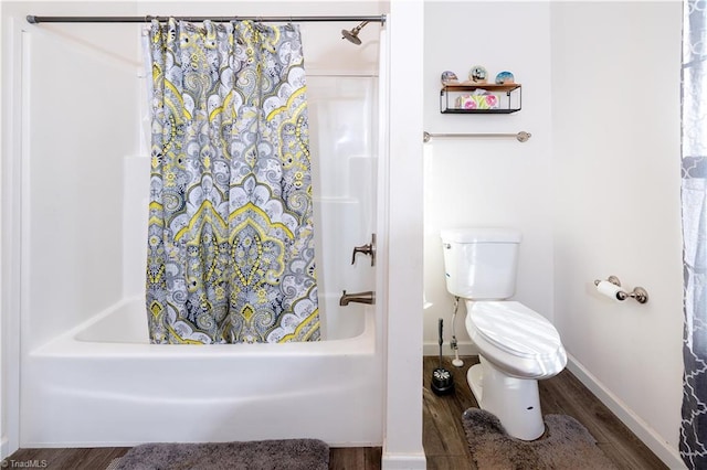 bathroom with hardwood / wood-style flooring, toilet, and shower / tub combo with curtain