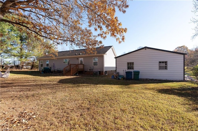 rear view of property featuring a yard