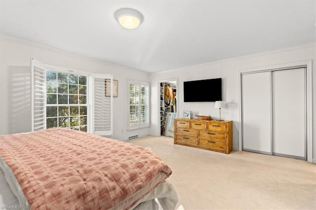 carpeted bedroom featuring two closets and ornamental molding