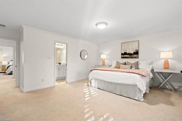 bedroom featuring light carpet, ornamental molding, and ensuite bathroom