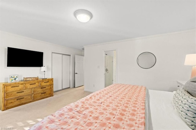 carpeted bedroom with ornamental molding and a closet