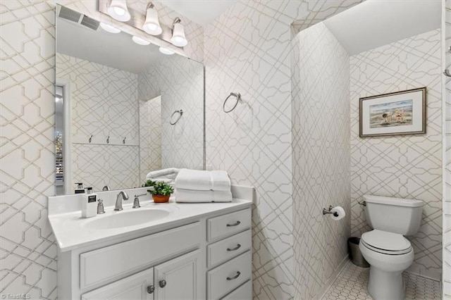 bathroom featuring tile patterned flooring, vanity, and toilet