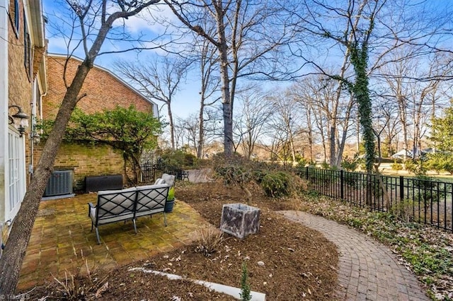 view of yard featuring central AC, an outdoor living space, and a patio area