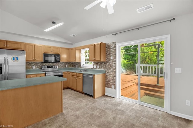 3931 Hickswood Forest Dr, High Point, NC 27265 - kitchen featuring stainless steel appliances, vaulted ceiling, backsplash, a sink, and a ceiling fan