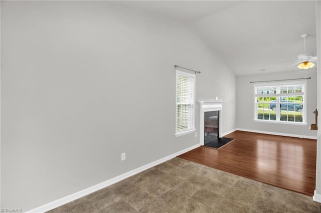 3931 Hickswood Forest Dr, High Point, NC 27265 - unfurnished living room featuring lofted ceiling, a glass covered fireplace, ceiling fan, baseboards, and wood finished floors
