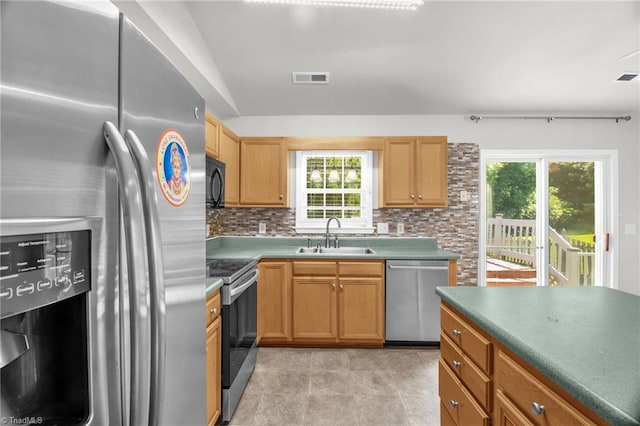 3931 Hickswood Forest Dr, High Point, NC 27265 - kitchen with appliances with stainless steel finishes, a sink, tasteful backsplash, and plenty of natural light