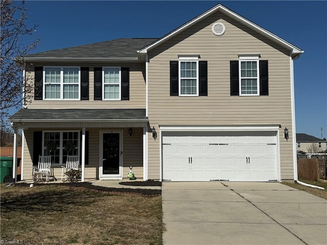 traditional home with covered porch, concrete driveway, and a garage