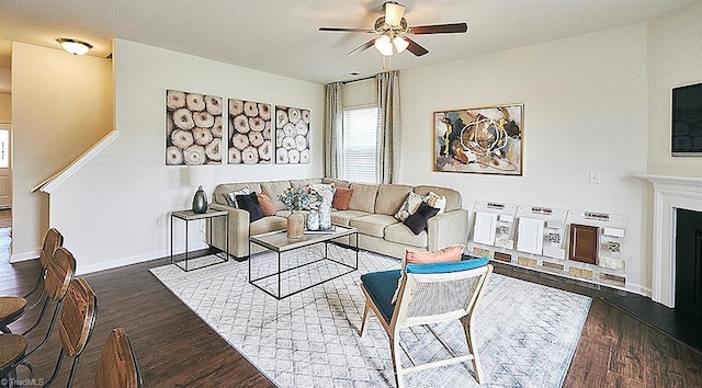 living room with ceiling fan and dark hardwood / wood-style floors