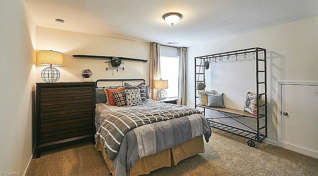 bedroom with dark colored carpet