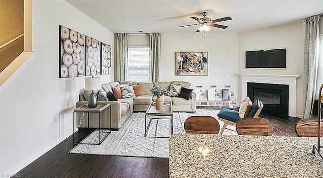 living room with dark hardwood / wood-style floors and ceiling fan