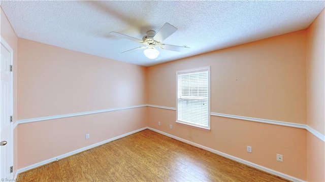 unfurnished room featuring ceiling fan, light hardwood / wood-style floors, and a textured ceiling