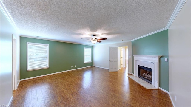 unfurnished living room featuring crown molding, wood-type flooring, and a textured ceiling