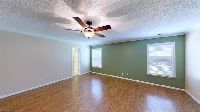 unfurnished room with hardwood / wood-style floors, a textured ceiling, ceiling fan, and crown molding