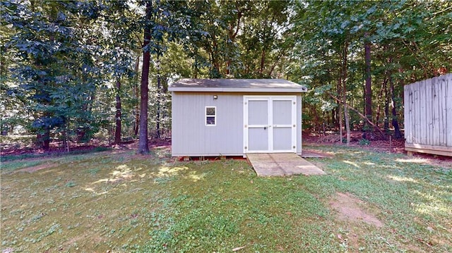 view of outbuilding featuring a yard