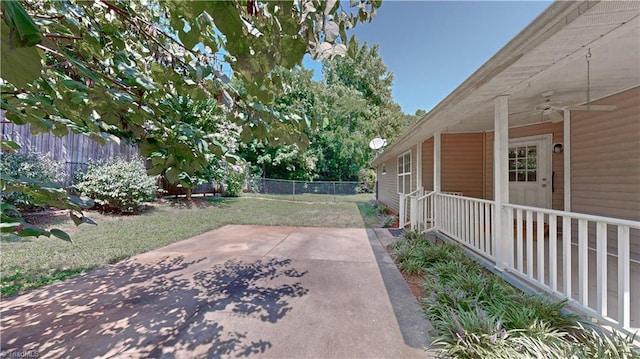 view of yard featuring ceiling fan and a patio area