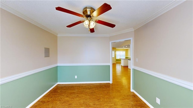 unfurnished room with a textured ceiling, hardwood / wood-style flooring, ceiling fan, and crown molding