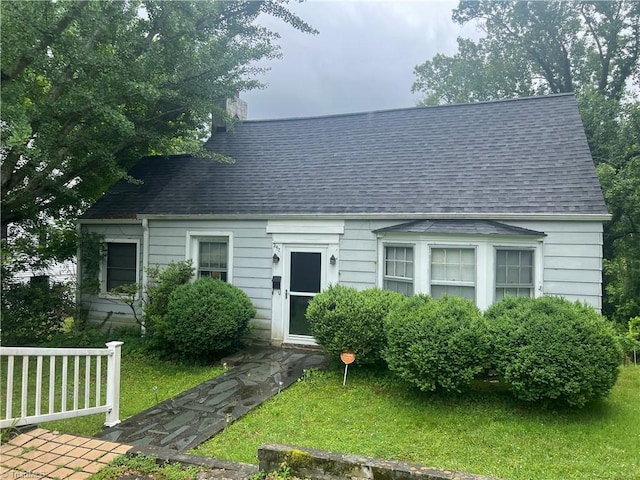 342 Moore Ave, Mount Airy, NC 27030 - new england style home with a shingled roof, a chimney, and a front lawn