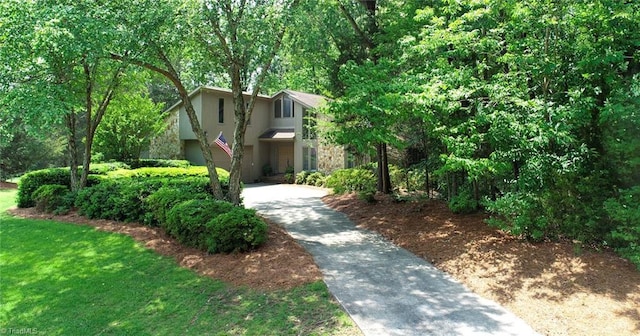 8009 Willow Glen Trl, Greensboro, NC 27455 - view of front of home featuring stucco siding, driveway, and stone siding
