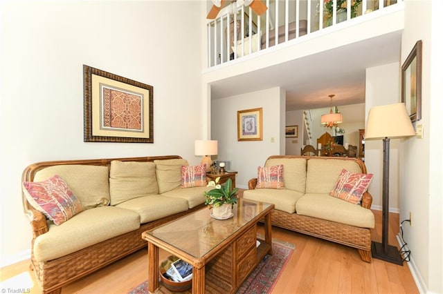 8009 Willow Glen Trl, Greensboro, NC 27455 - living area featuring light wood-style flooring, baseboards, and a towering ceiling