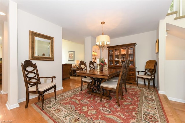 8009 Willow Glen Trl, Greensboro, NC 27455 - dining space with light wood finished floors, baseboards, and a chandelier