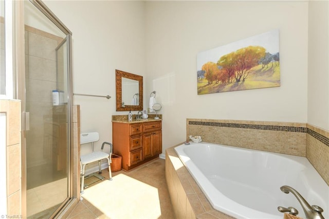 8009 Willow Glen Trl, Greensboro, NC 27455 - full bathroom with a shower stall, vanity, a garden tub, and tile patterned flooring