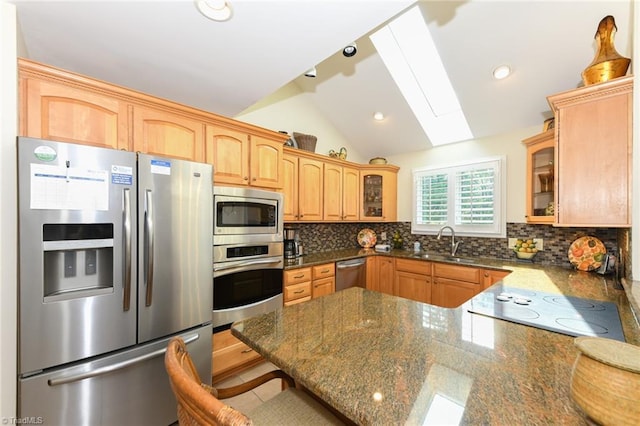 8009 Willow Glen Trl, Greensboro, NC 27455 - kitchen featuring appliances with stainless steel finishes, a sink, glass insert cabinets, vaulted ceiling, and backsplash