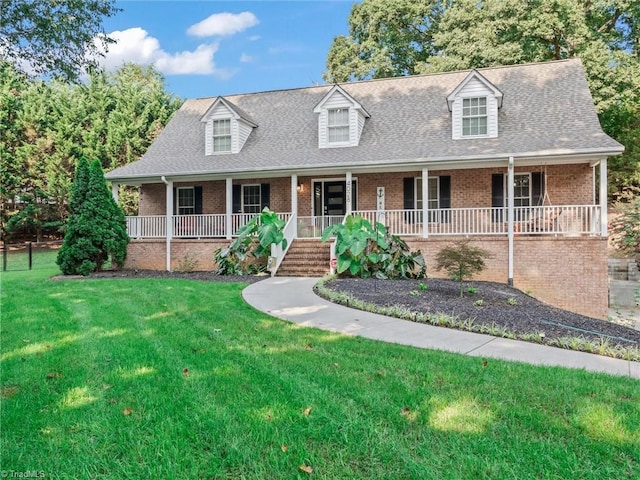 cape cod home with a porch and a front yard