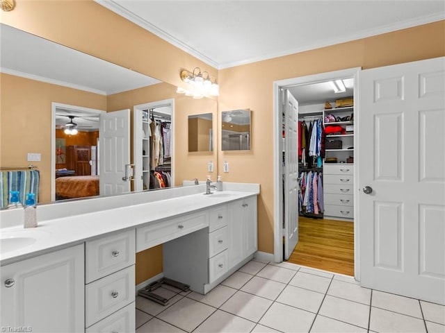 bathroom featuring ceiling fan, vanity, tile patterned floors, and crown molding