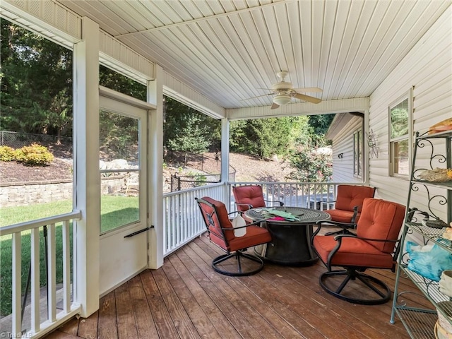 sunroom featuring ceiling fan