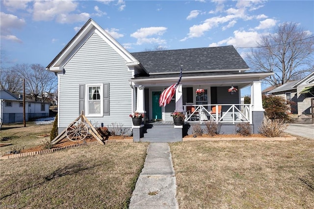 bungalow with a front lawn and a porch