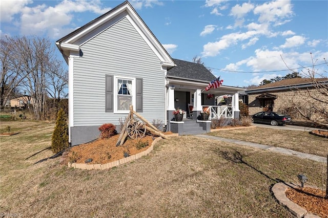 view of front of house with a front yard and a porch