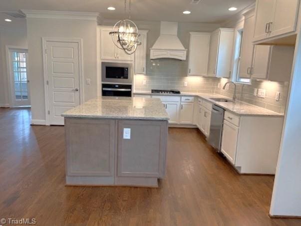 kitchen featuring white cabinets, custom range hood, a sink, wall oven, and dishwasher