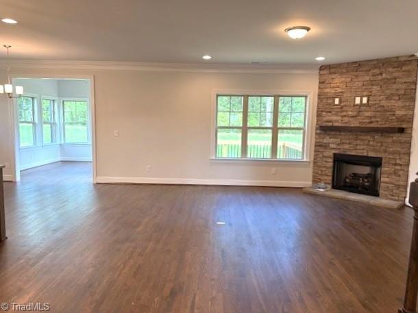 unfurnished living room with dark wood-style flooring, crown molding, and baseboards