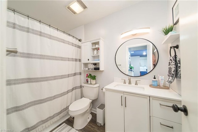 full bath with toilet, vanity, and wood finished floors