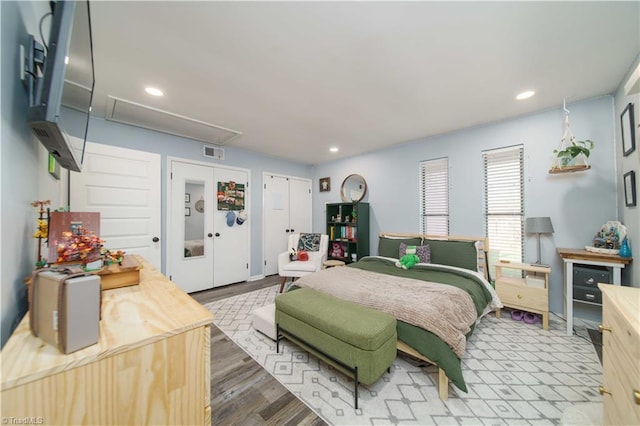 bedroom with attic access, recessed lighting, and wood finished floors