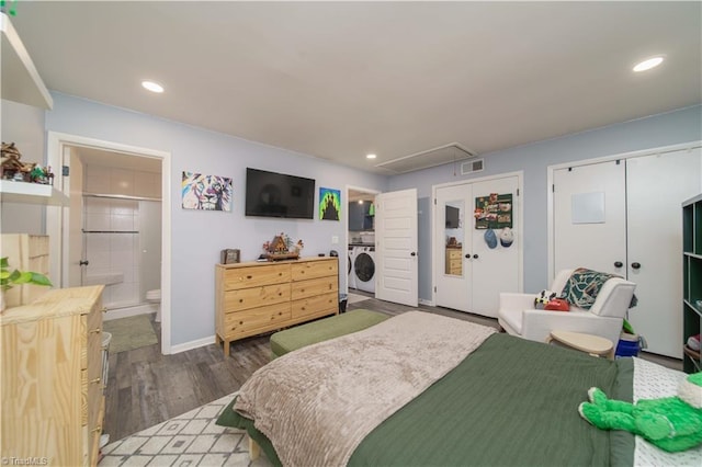 bedroom featuring attic access, wood finished floors, recessed lighting, separate washer and dryer, and connected bathroom