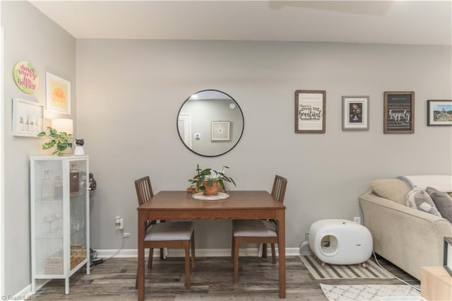 dining area featuring wood finished floors and baseboards