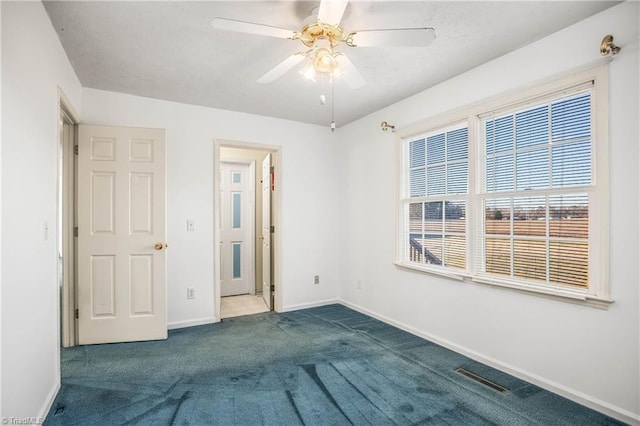 interior space with carpet flooring and ceiling fan