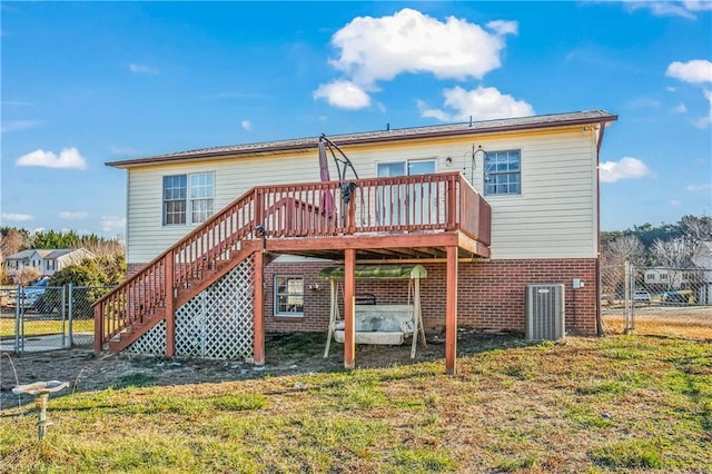 back of property with central AC unit, a yard, and a wooden deck