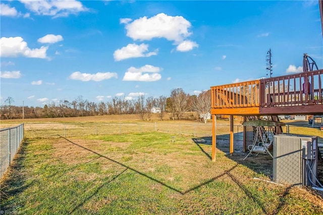 view of yard with central air condition unit, a rural view, and a deck