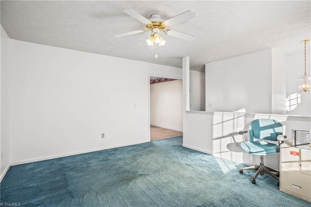 unfurnished room featuring a textured ceiling, carpet, and ceiling fan with notable chandelier