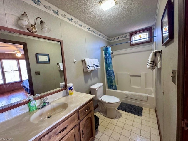 full bathroom with shower / bath combo, tile patterned floors, vanity, a textured ceiling, and toilet