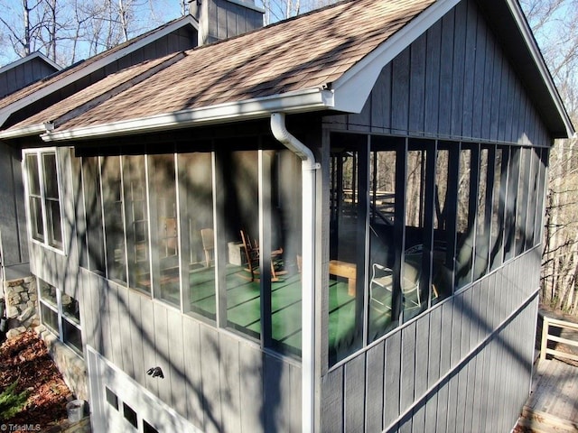 view of property exterior with a sunroom