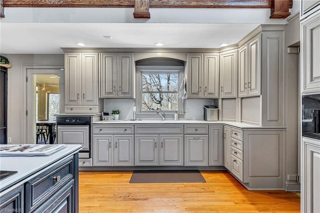 kitchen featuring gray cabinets, sink, and light hardwood / wood-style flooring